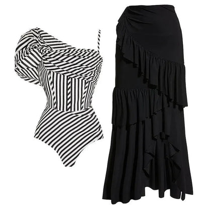Women's striped one-piece swimsuit with ruffled design and black skirt overlay
