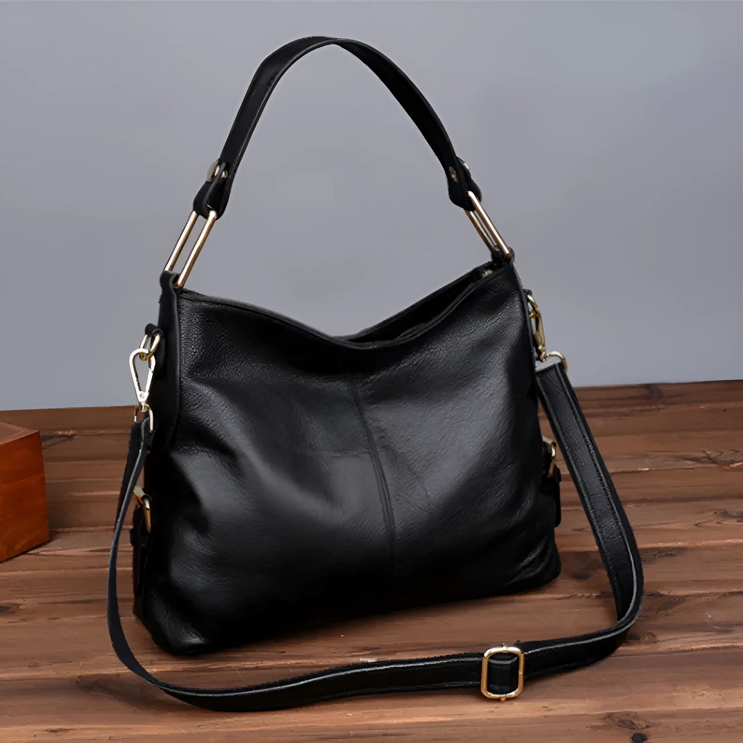 Black genuine leather vertical crossbody bag with multiple internal compartments and a sandwich pocket.