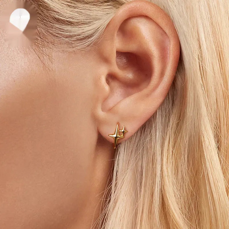 Sterling silver minimalist star ear clip with oxidised finish and XINGX design detail.