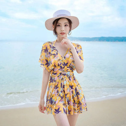 Yellow floral pattern women's one-piece swimsuit on hanger