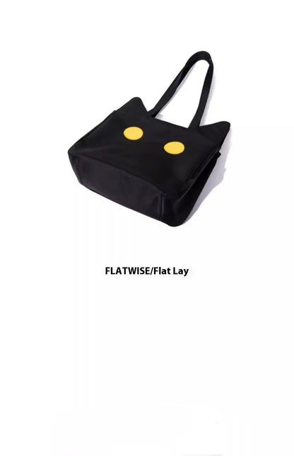 Black cat-shaped nylon tote bag with medium-soft structure, nylon lining, and sandwich zipper pocket, 34cm x 13cm x 27cm.