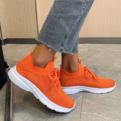 Women's Flyknit mesh running shoes in milky white with a low flat heel and rubber sole