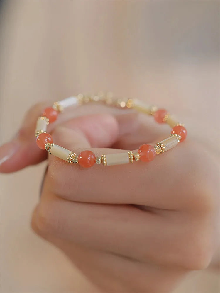 Women's Hetian jade bracelet with bamboo joint design on a white background.