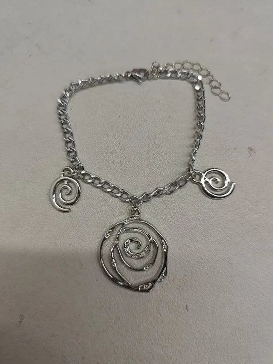 Gold spiral donut alloy jewellery set showing adjustable necklace, matching bracelet, and ear hooks on a plain background.