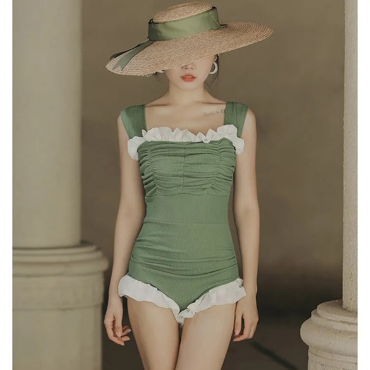Women's black high-waisted one-piece swimsuit made from quick-drying polyester fabric.
