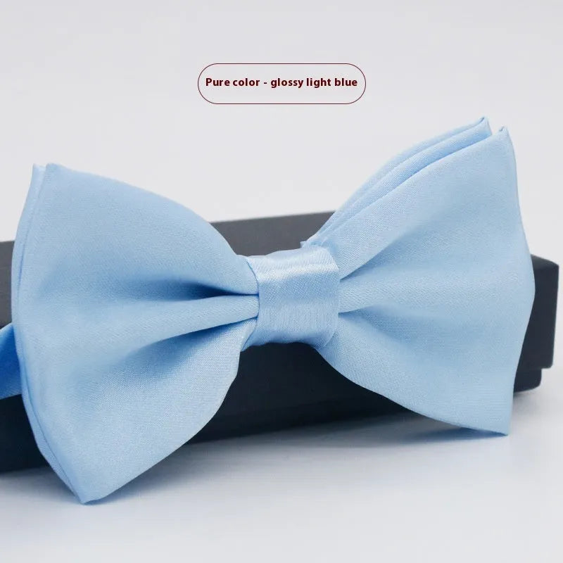 A solid colour pre-tied bow tie with an adjustable neck strap, shown in a classic flat head shape.