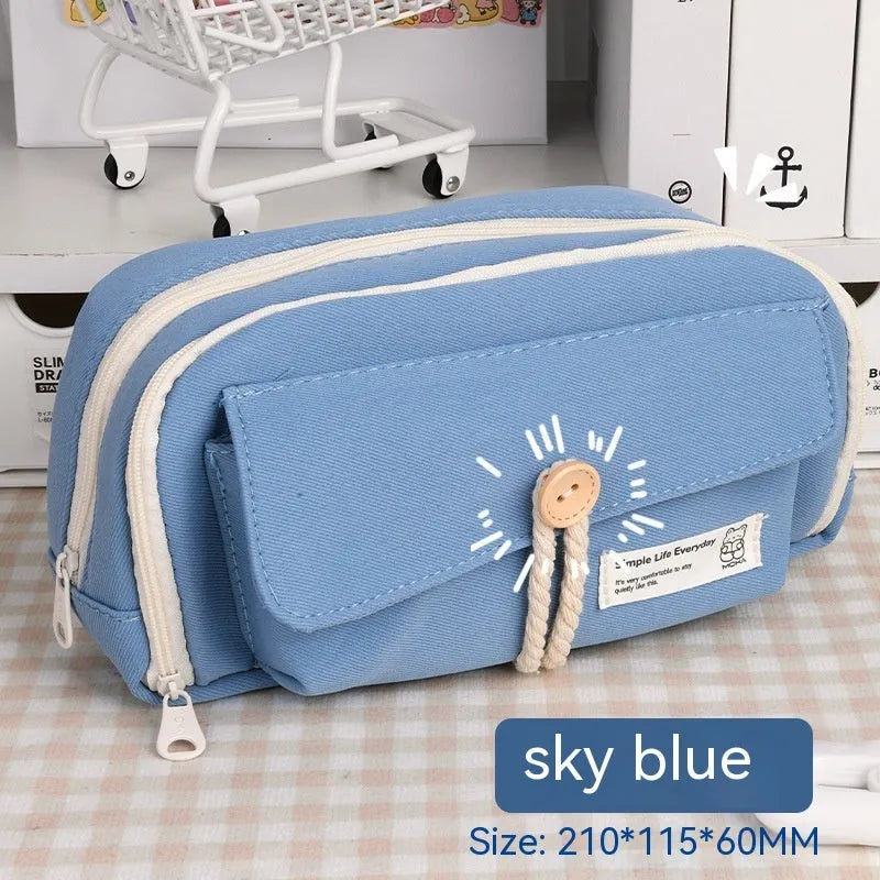 Korean style canvas pencil case with button closure, shown in beige, holding multiple pens.