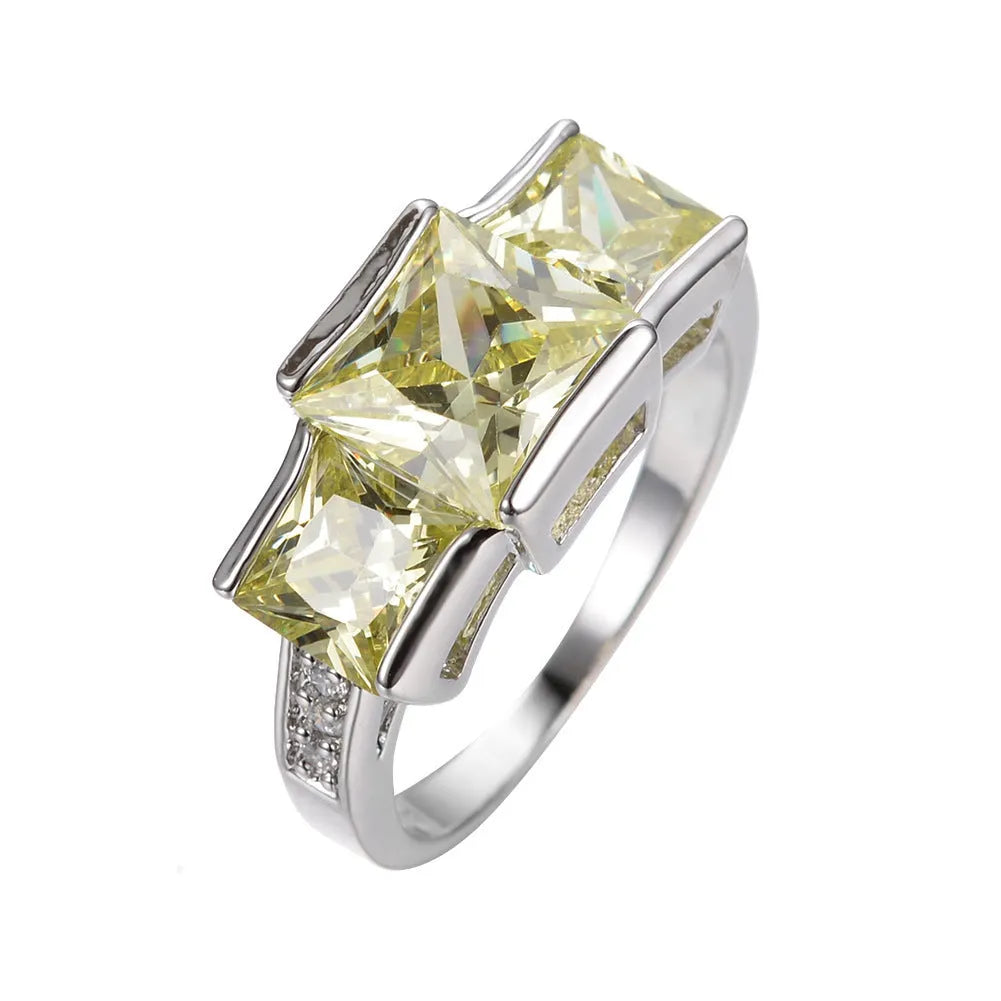 Aier Moxa geometric copper fashion ring in assorted electroplated colours on a plain background.