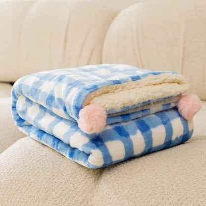A blue coral fleece pet blanket laid flat, showing its soft texture and rectangular shape as a dog or cat bed mat.