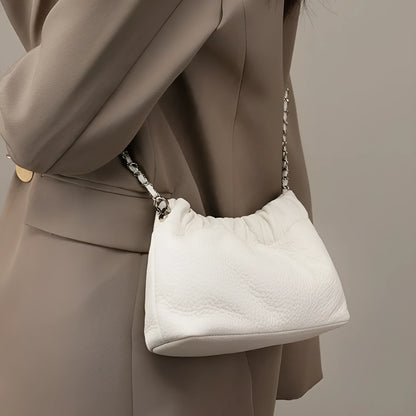 Women's dumpling-shaped genuine leather crossbody bag in three neutral colours showing slit pocket
