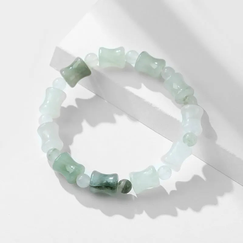 Simple Korean-style bracelet with natural chalcedony and coconut shell beads on an elastic string, showing the diamond-shaped safety lock.