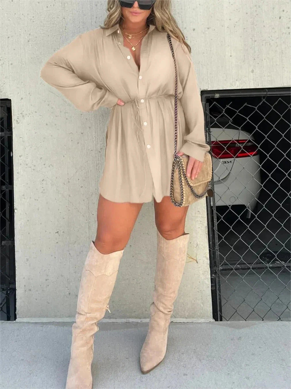 A stylish long sleeve jumpsuit with a button-up shirt design, available in a variety of vibrant colors.