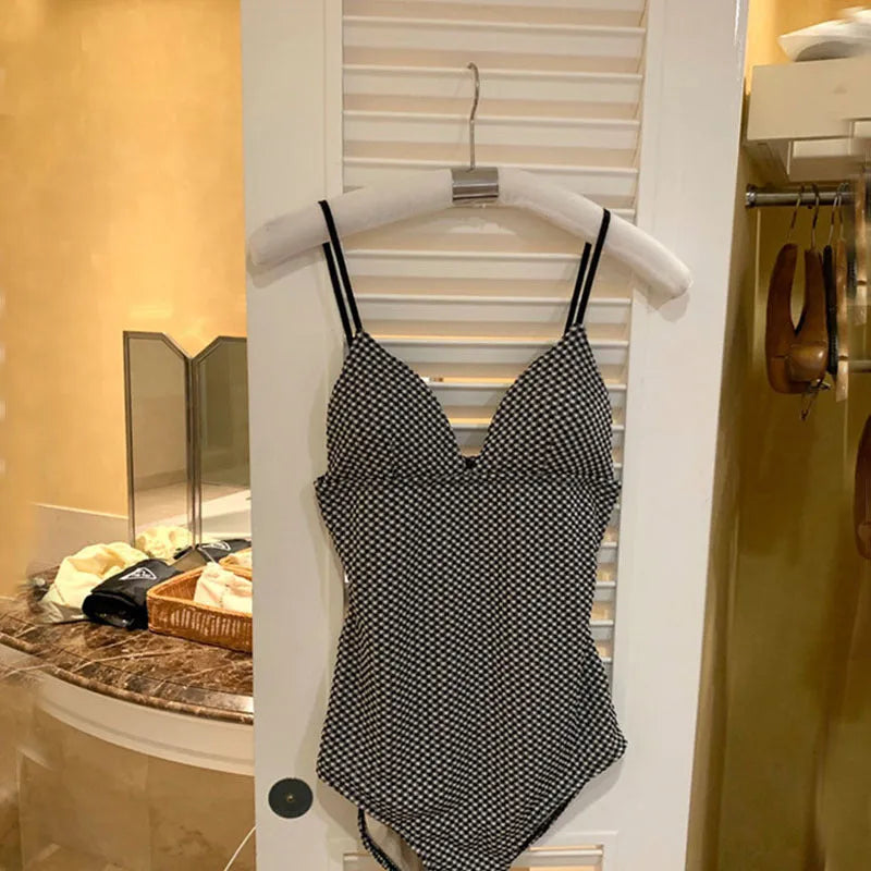 Blue one-piece swimsuit for women with design for small chest and stomach coverage.
