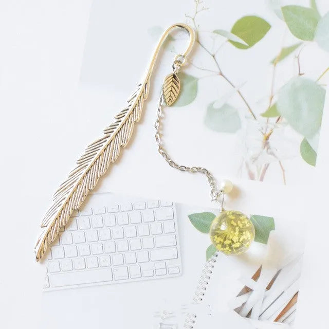 Dried flower bookmark with alloy frame measuring 12cm by 2cm, showing preserved botanical specimens