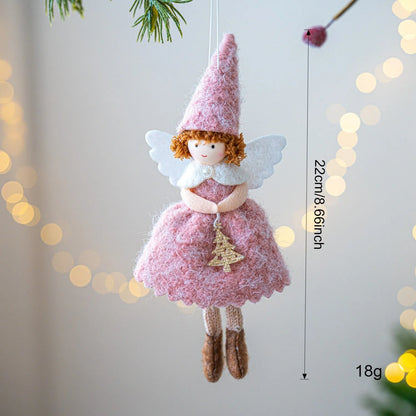 White and pink cloth felt Christmas angel skirt pendant ornament on a tree branch.