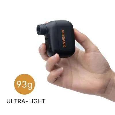 Black AS100 electric bicycle pump with digital display, USB charging port, and included waterproof bag