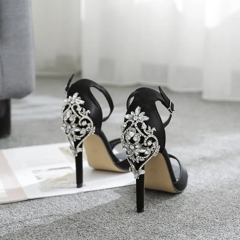 Black suede women's high heel shoes with rhinestone detail and a peep-toe.