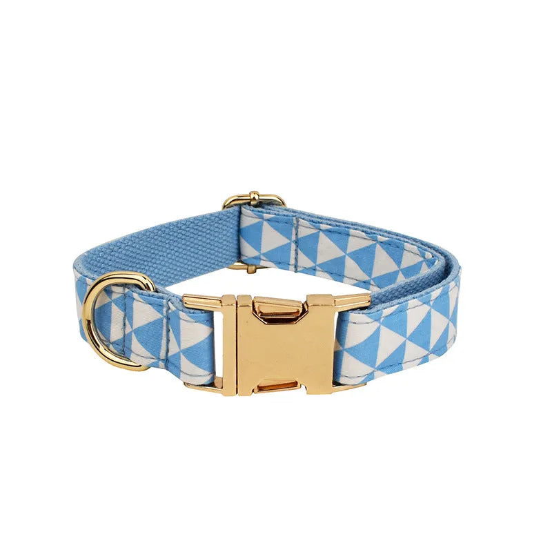 Blue cloth dog accessory set with collar, leash, bow, and vest shown together