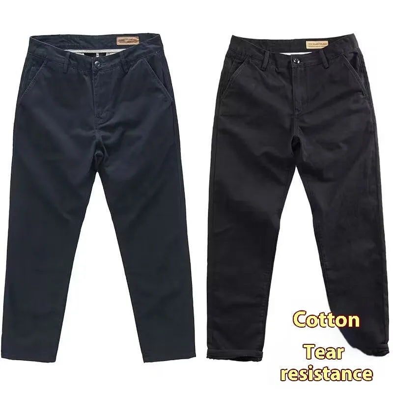 Man wearing slim fit grey micro elastic washed trousers with a straight leg cut for a business casual look.