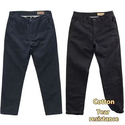 Man wearing slim fit grey micro elastic washed trousers with a straight leg cut for a business casual look.