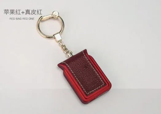 Black leather Bluetooth Dual SIM Adapter keychain with Nano SIM slot and Micro USB port.