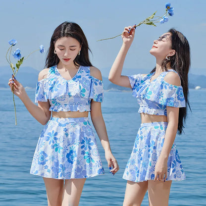Women's fresh floral blue one-piece swimsuit dress showing front view