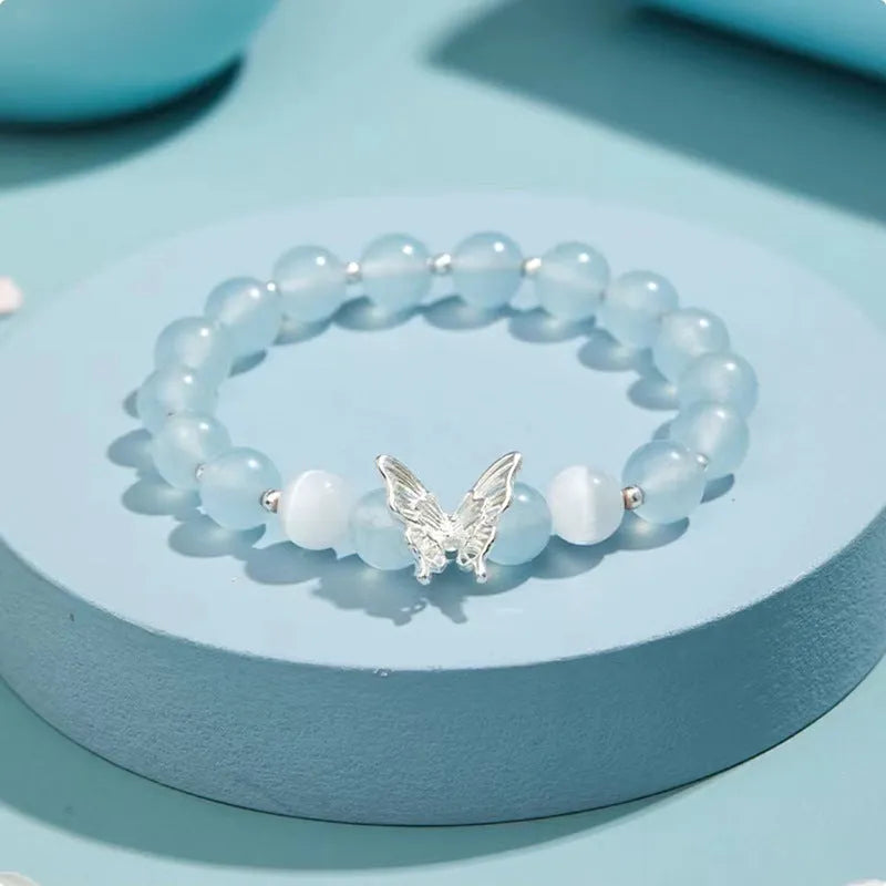 Women's crystal bow bracelet with butterfly design in ocean blue, pink, and purple colour options