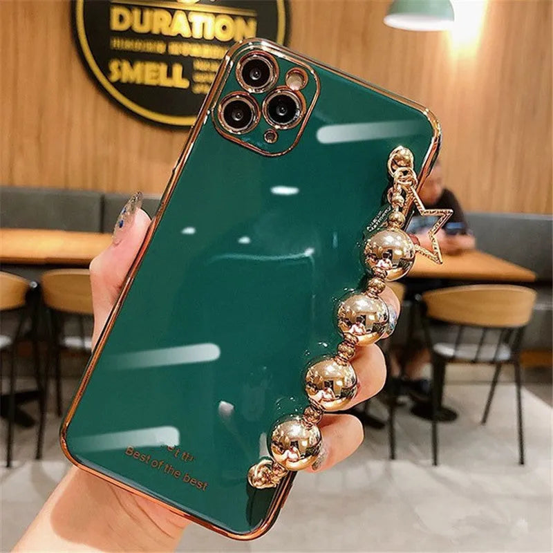 Electroplated bead wrist strap bracelet case for iPhone in light green, pink, and dark green, TPU back cover.