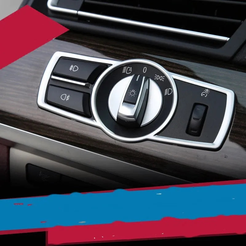Silver ABS plastic decorative sticker for BMW headlight switch frame on dashboard.