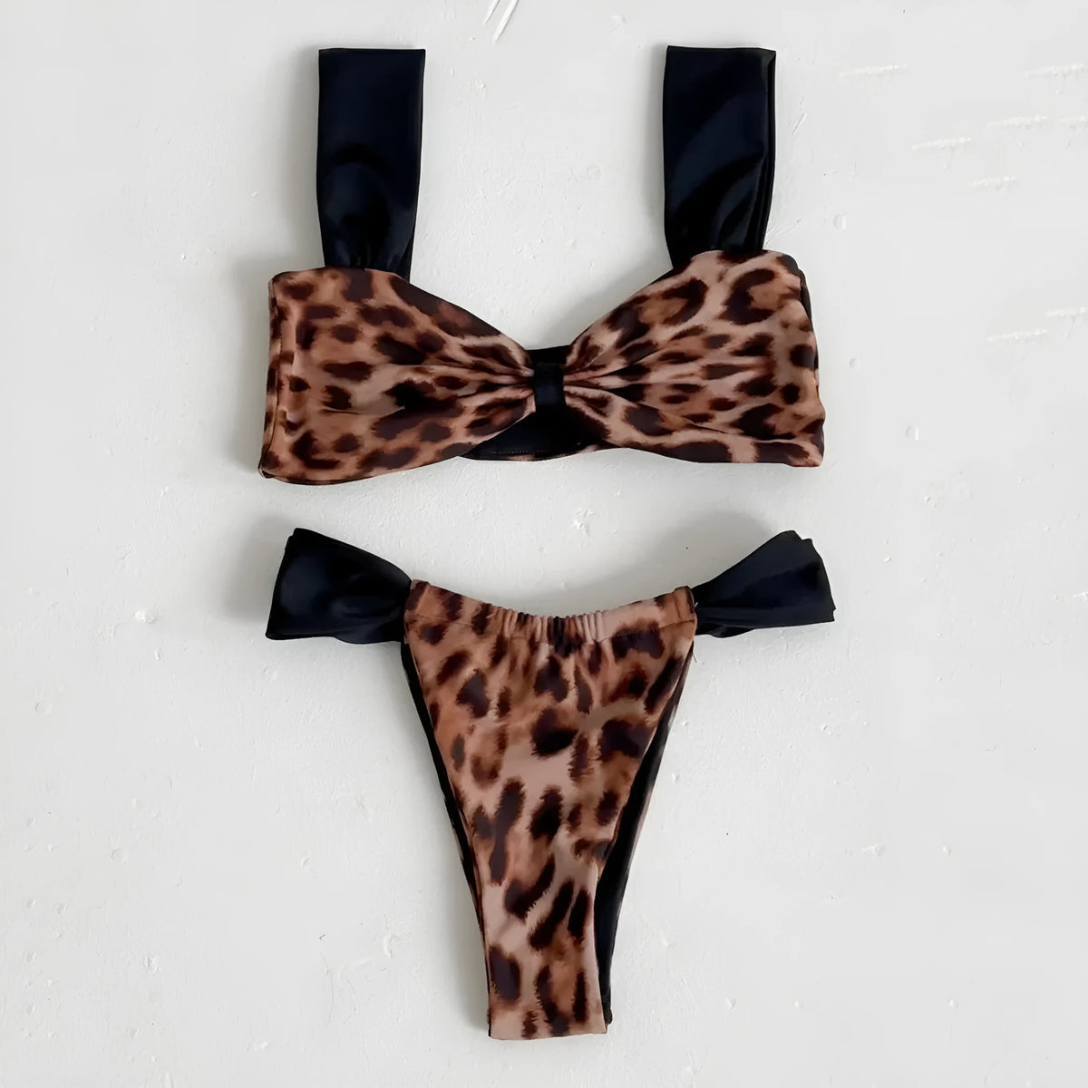 Women's black and leopard print bikini set with tube top and T-pants briefs on a mannequin.