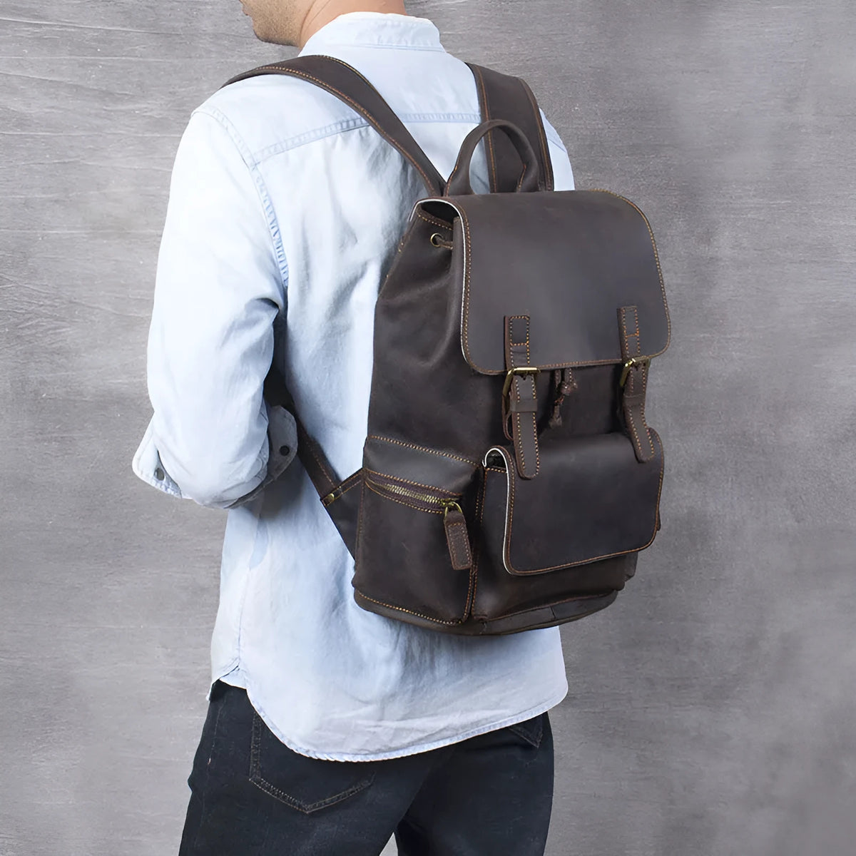 Retro brown genuine cowhide leather backpack with shoulder straps and a top handle.
