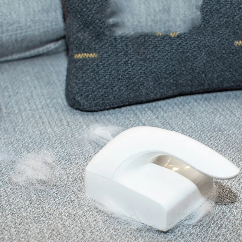 White ABS plastic reusable pet hair remover roller for cat and dog fur on fabrics.