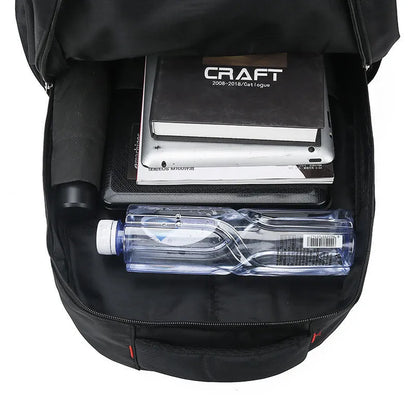 Large black nylon backpack with curved shoulder straps and letter detailing, shown from the side.