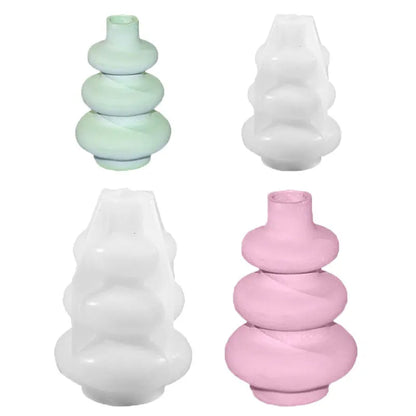 Silicone baking mould in shape of three-layer irregular circle vase on white background