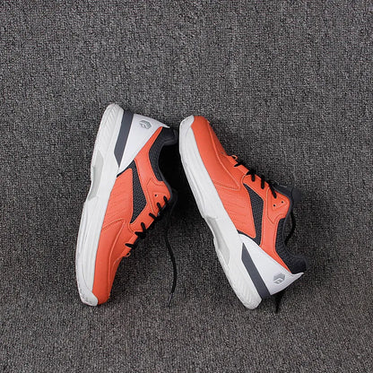 Orange men's wide fit tennis shoes with suede and mesh upper, lace-up closure, and rubber outsole.