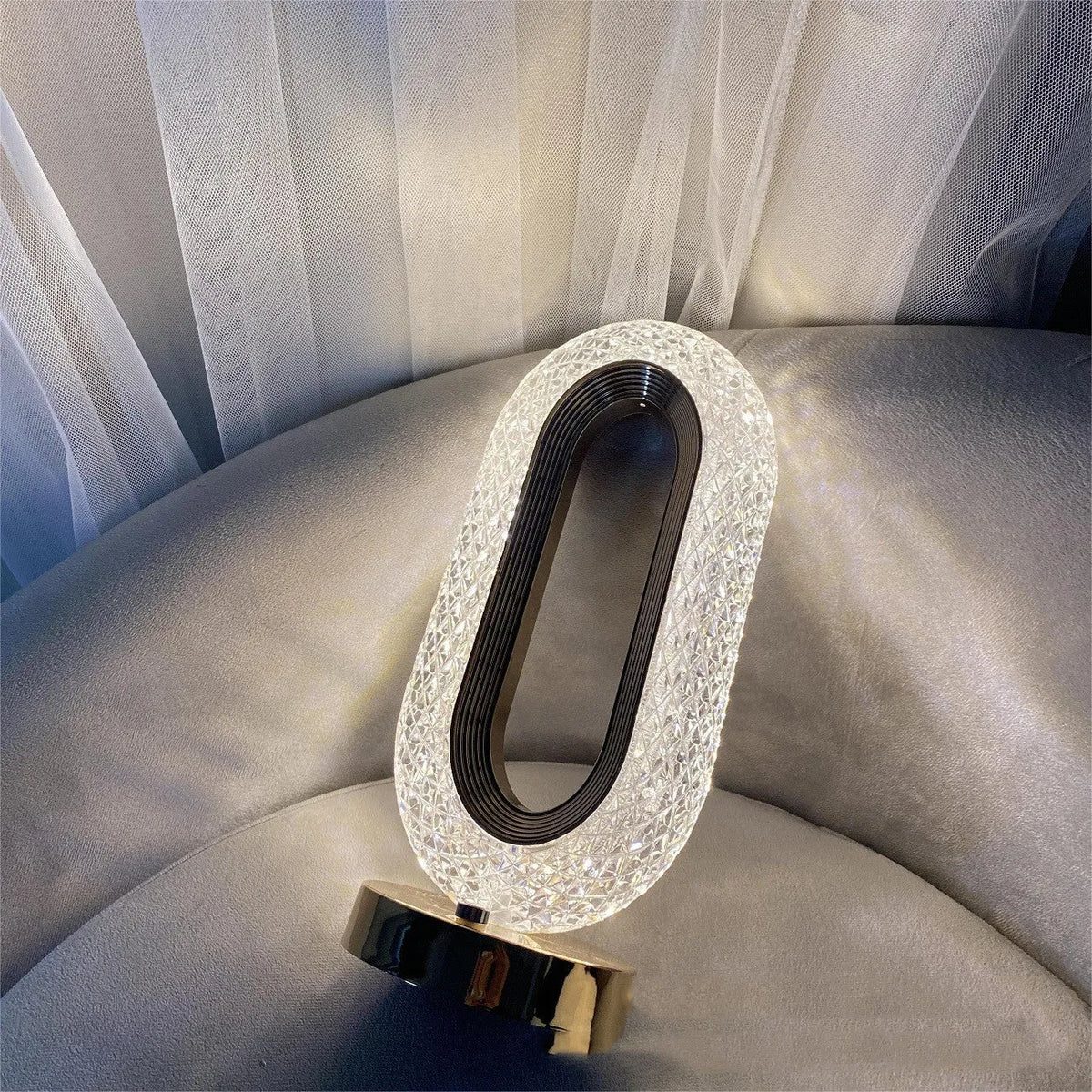 Modern minimalist O-shaped crystal desk lamp with touch dimming control on metal base