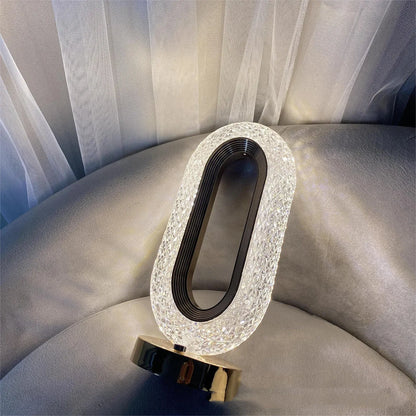 Modern minimalist O-shaped crystal desk lamp with touch dimming control on metal base