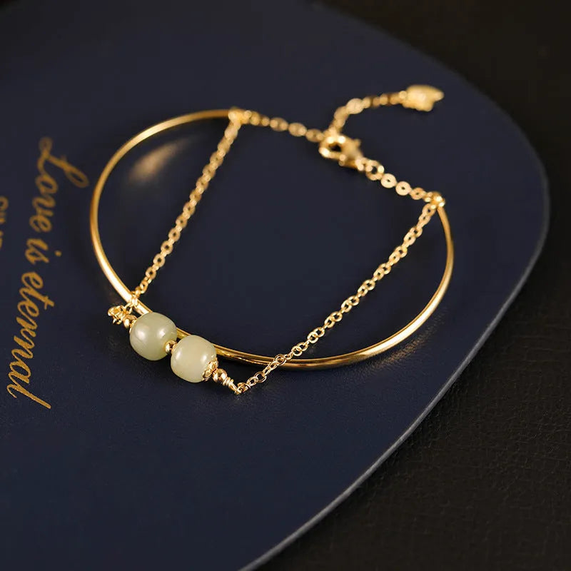 Women's Hetian jade lucky beads bracelet with gold inlay, shown in faux two-piece design.