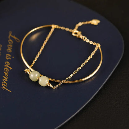 Women's Hetian jade lucky beads bracelet with gold inlay, shown in faux two-piece design.
