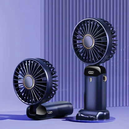 Blue foldable mini handheld electric fan showing its LED display and hanging lanyard.