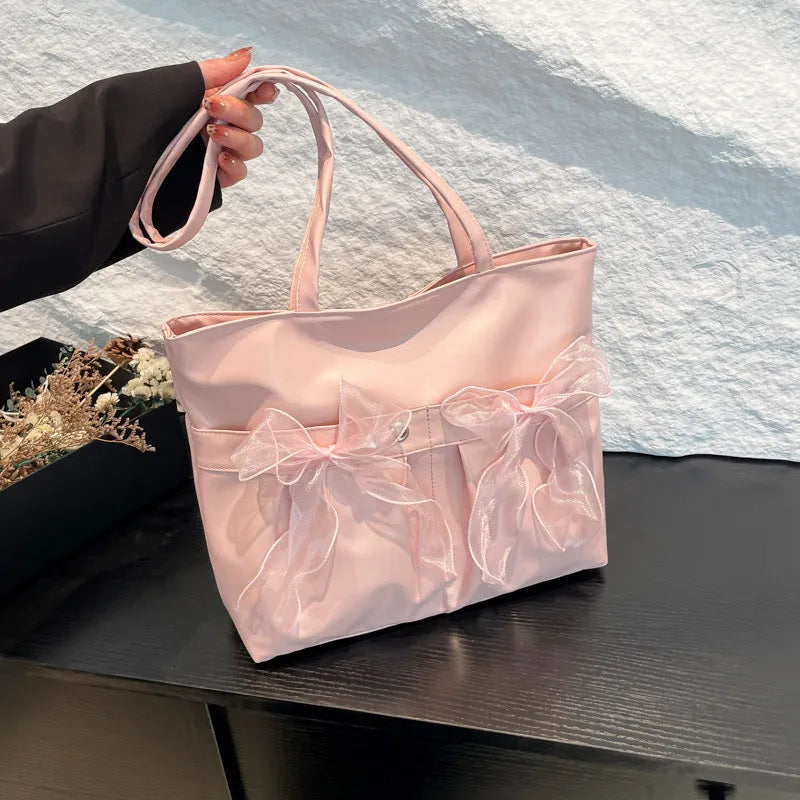 College style bow tote bag large capacity casual shoulder bag for women made from black or pink PU leather with double connector straps and internal zipper change compartment
