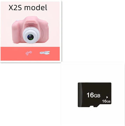 X2 HD mini digital camera for kids in silicone case with lanyard, shown capturing photo on 2-inch screen.