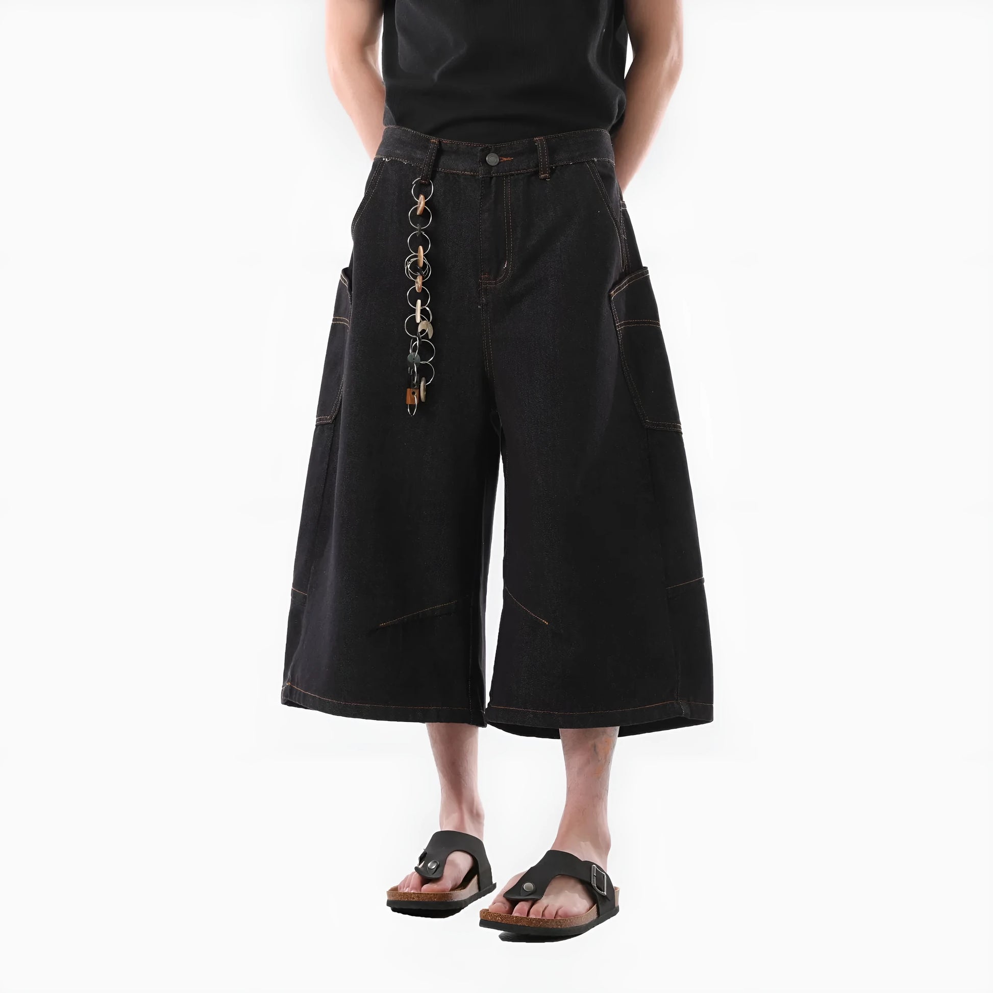 Black retro washed cropped denim trousers for men on a hanger