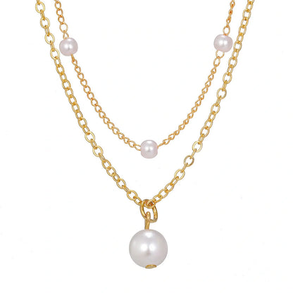 Elegant gold pearl tassel necklace with double-layered design and adjustable chain