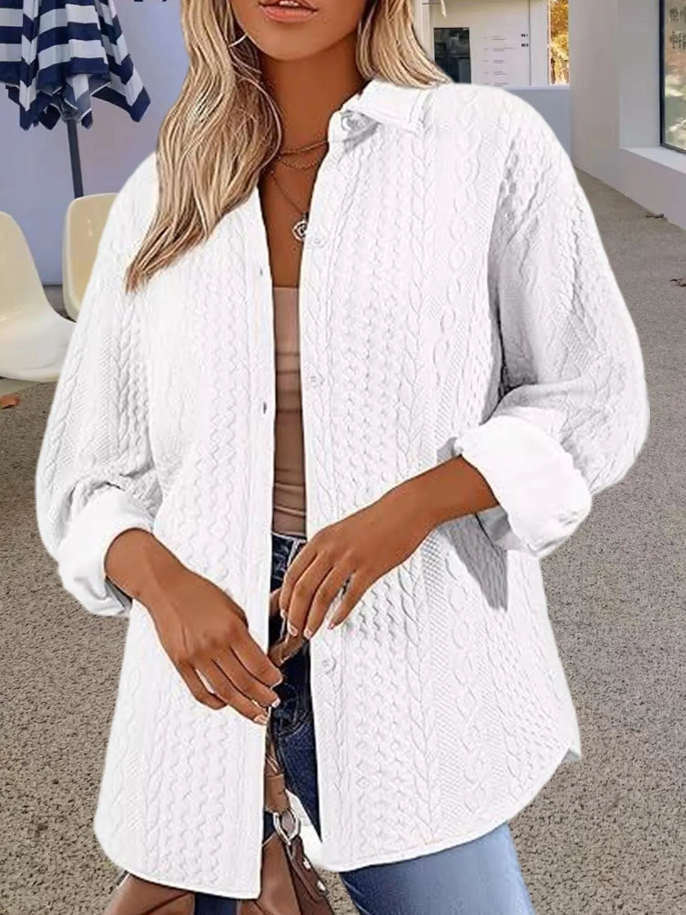 Women's solid colour long-sleeved cardigan sweater in black, shown in a commute-style setting.