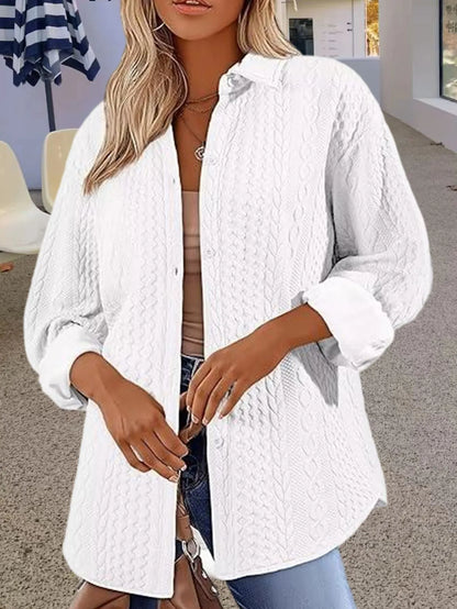 Women's solid colour long-sleeved cardigan sweater in black, shown in a commute-style setting.