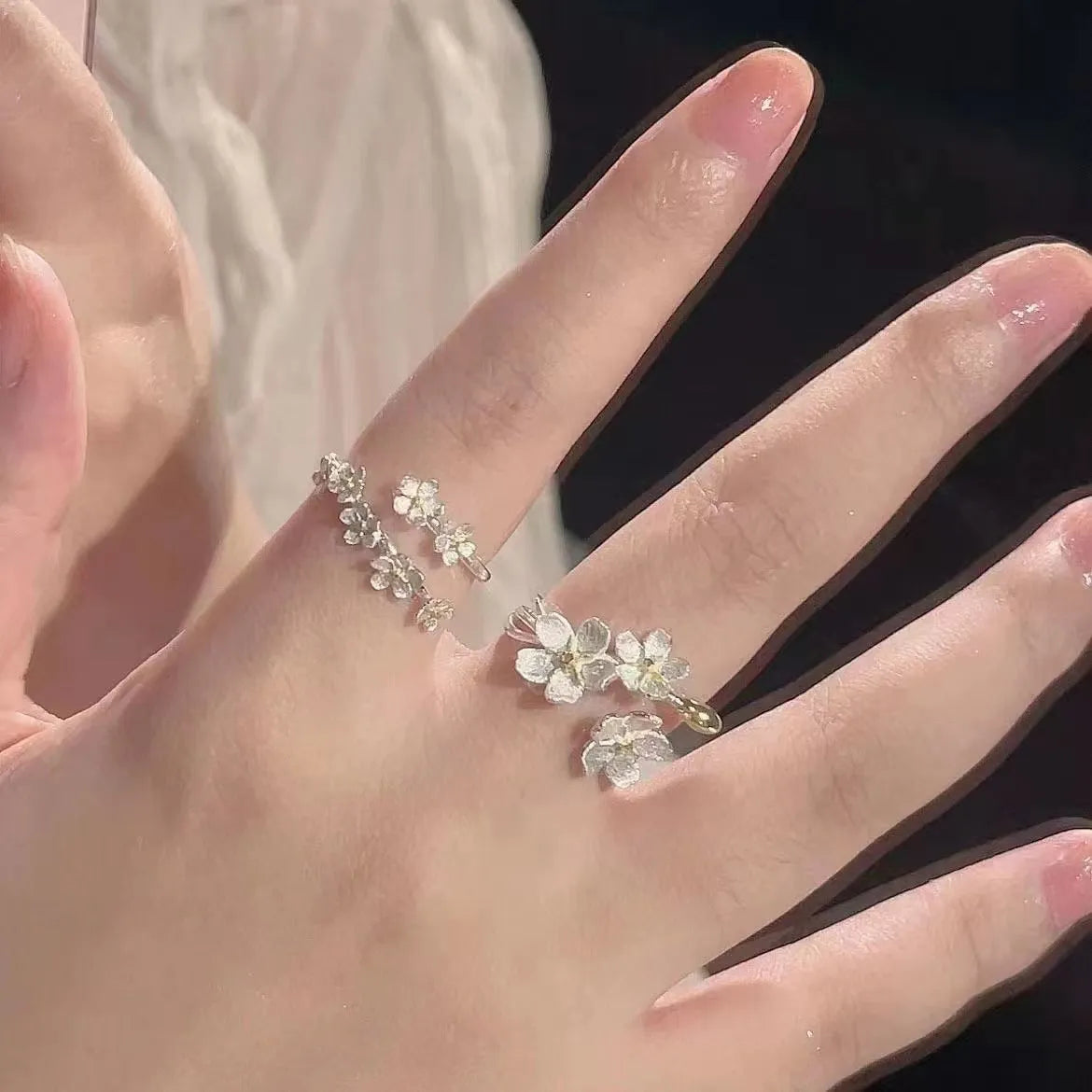 Adjustable open-mouth ring with detailed 3D jasmine flowers, available in three, five, or seven-flower styles.