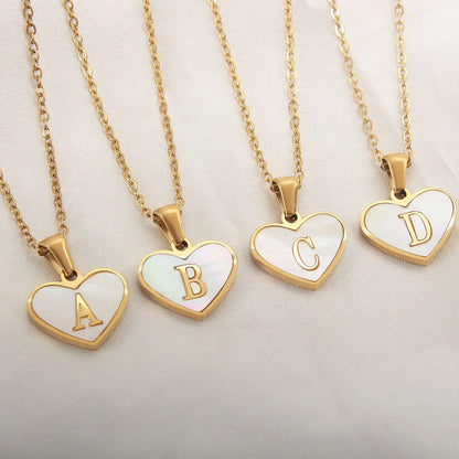 Gold-plated heart necklace with white shell pendant showing letter personalisation option