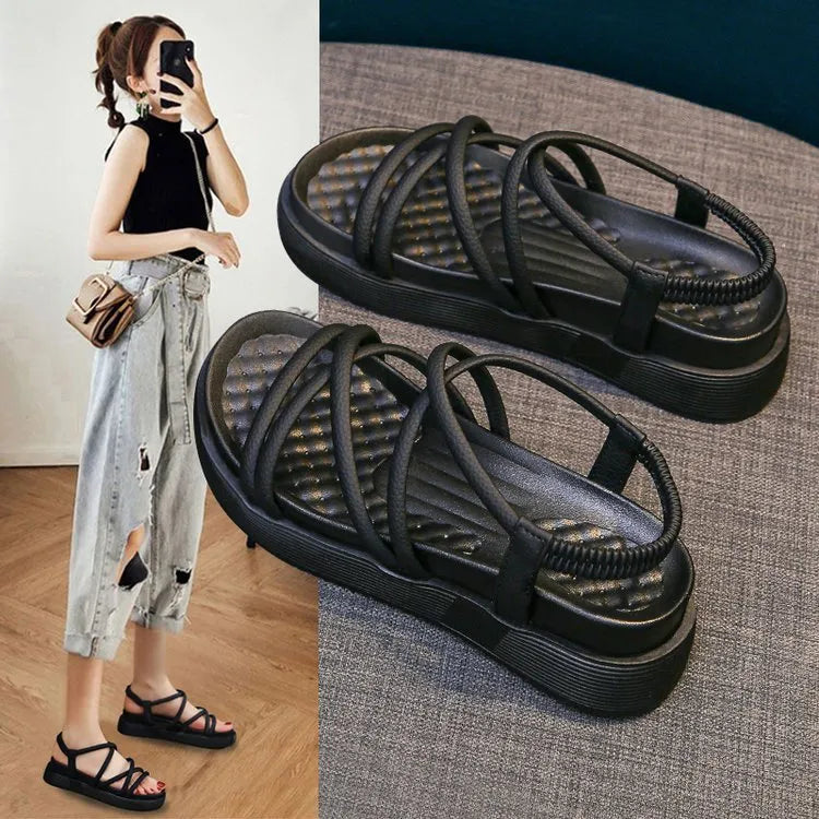 Women's black Roman platform sandals with straps on a white background.