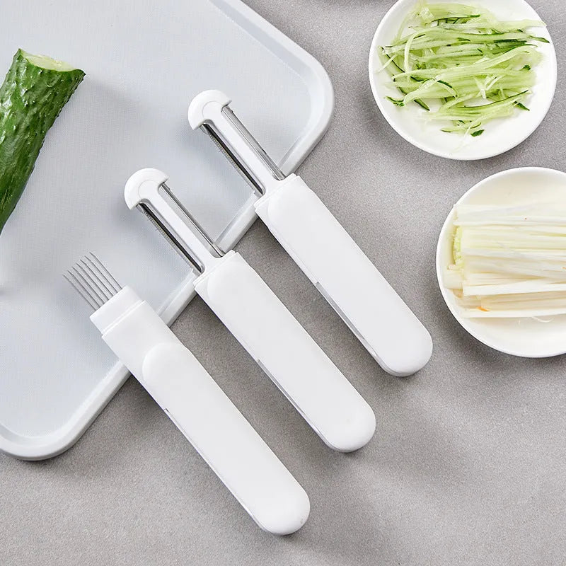 Multifunctional kitchen peeler with 360 rotating stainless steel blade functions as a paring knife and grater tool for vegetables and fruits, featuring an ergonomic PP handle and sharpening slots in white.